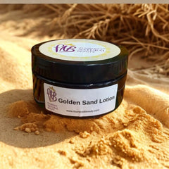 Elegant bottle of Golden Sand Lotion on a golden sand surface.